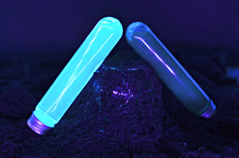 Glowing lightsaber cocktails in tall test-tube glasses