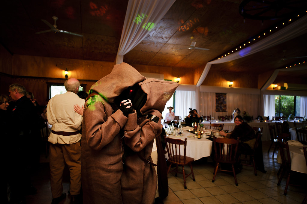 Two guests in Jawa costumes slow dance at a Star Wars wedding reception