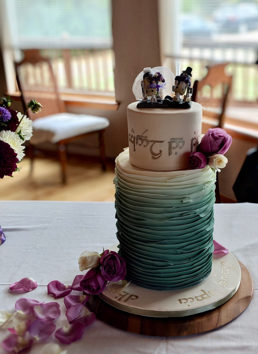 Ombre ruffled wedding cake with a Lego bride and groom topper and cascading roses