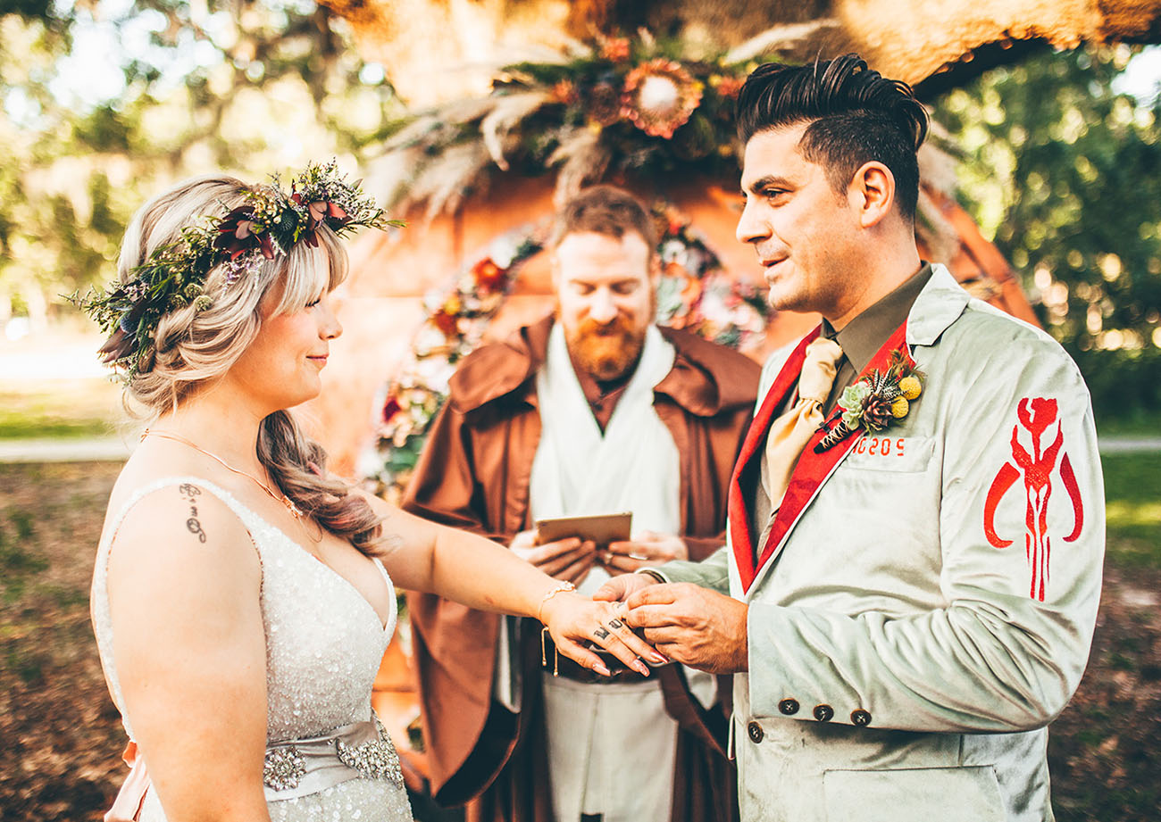 A fully styled Star Wars ceremony with a Jedi-robed officiant and floral arch