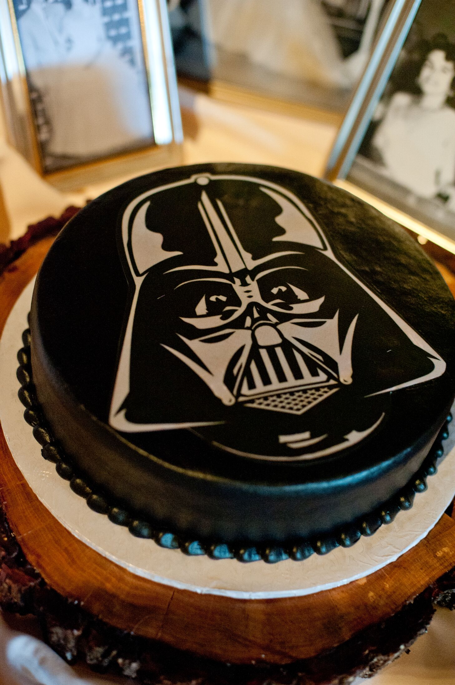All-black Darth Vader groom's cake on a wood slab